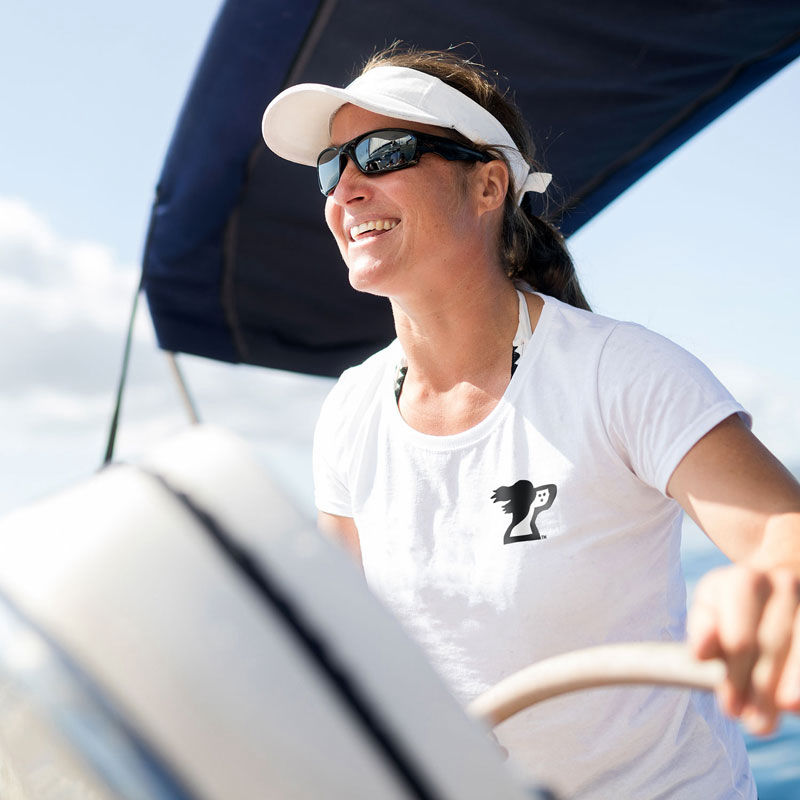 Harbor Springs Michigan sailing woman on bay with a springer spaniel dog logo on a t-shirt from the Harbor Springer apparel shop.